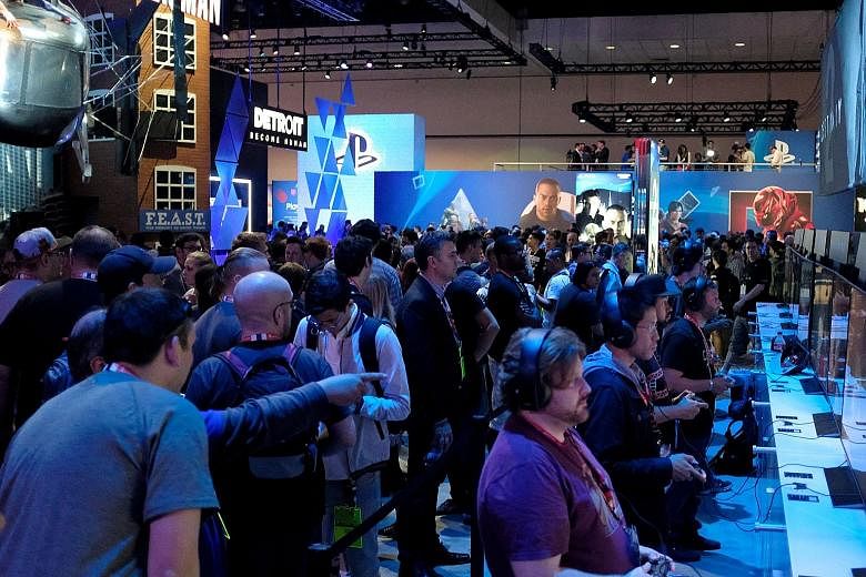 Visitors trying out games at the Sony PlayStation Booth during the Electronic Entertainment Expo 2017 in Los Angeles last week. Sony is focusing more on games as it feels that is what people are looking forward to.