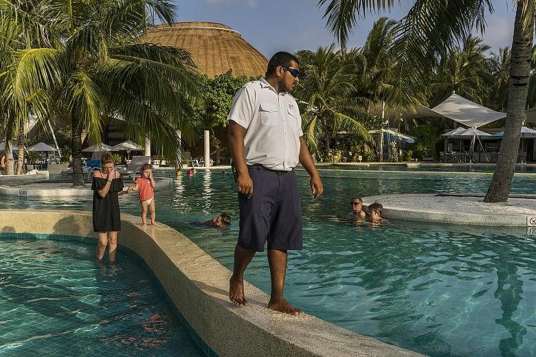 A security guard keeping watch over guests at a resort in Maldives. Many fear that the tourist haven is ill equipped to fend off a terror attack.