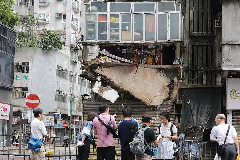 Part of the concrete floor of this second-floor unit in Hong Kong crumbled under torrential rain early yesterday. Twenty-two residents were evacuated. The local authorities said the block was not in immediate danger of collapse and the residents may 