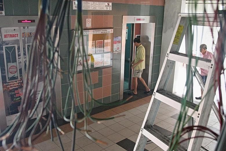 The fire at Block 14A in Lorong 7 Toa Payoh damaged the wiring (left) in the void deck ceiling, causing a power disruption. One of the lifts was working again by about 10pm on Tuesday. Poly student Hilman Hasbullah had to throw away food in the fridg