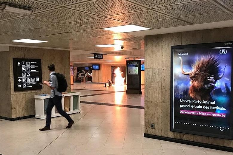 The bag holding a bomb caught fire after the device "partially exploded" at a train station in Brussels, Belgium, on Tuesday. The suspect, who had dropped the bag, was later shot dead by a soldier on patrol.