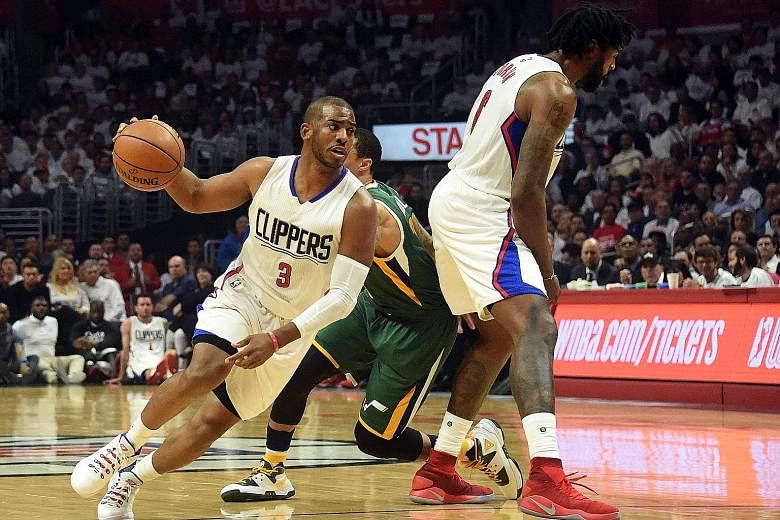 Los Angeles Clippers guard Chris Paul (left) using a screen by team-mate DeAndre Jordan to elude Utah Jazz guard George Hill during the NBA play-offs in April. With these two All-Star players in the fold, the Clippers are seen as a potential destinat