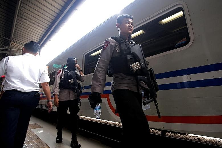 Armed police officers on patrol at a train station in Jakarta yesterday. Last year, there was a suicide bombing at a police station in Solo on the eve of Idul Fitri.
