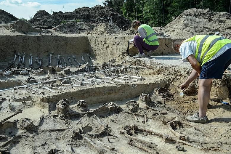 Archaeologists at work during excavations at expressway building S-17 Lublin - Warsaw in Zerdz, eastern Poland, yesterday. Scientists have discovered a burial place of what they believe were participants in the Battle of Zyrzyn that took place in 186