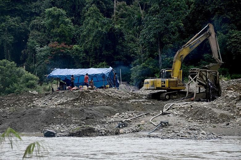 An illegal gold mine on the banks of the Tabir river in Indonesia's Sumatra island. With no regulation in the early days of the boom, miners became bolder and started openly using excavators.