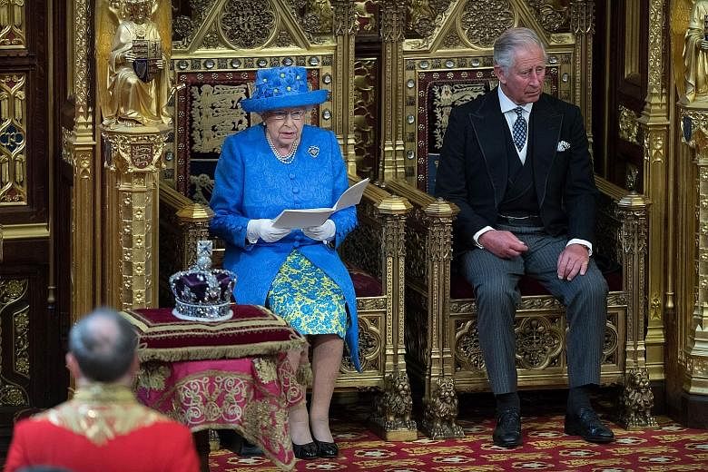 Queen Elizabeth, with Prince Charles beside her, delivering the Queen's Speech during the state opening of Parliament in London yesterday. Lawmakers will spend the next few days debating the government programme before bringing it to a vote next Thur
