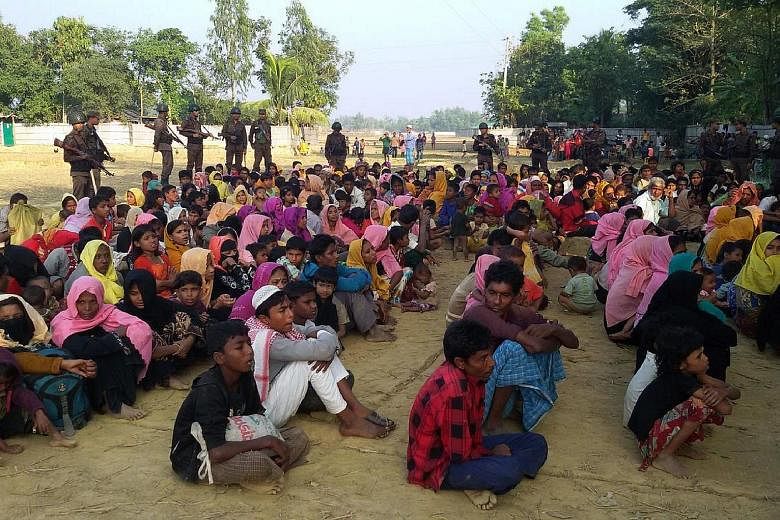 Bangladeshi forces keeping watch over a group of Rohingya who fled Myanmar. As it becomes harder for them to leave Bangladesh, many have been forced to head to places once considered less appealing.