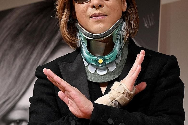 Yoshiki in a neck brace on Tuesday at his first press conference since emergency surgery to implant an artificial cervical disc.