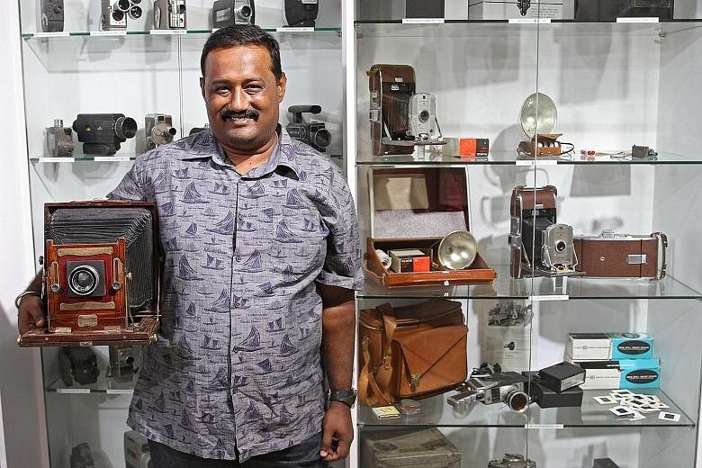 Mr S. Ramanathan, owner of the Vintage Camera's Museum (left), with a large format film camera.