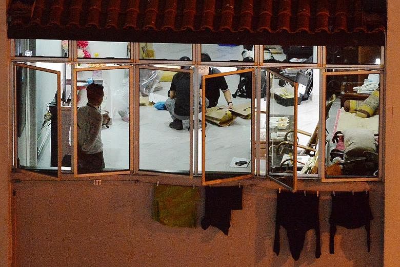 Above and right: Three knives were retrieved from a rubbish chute at the foot of Block 717, Bedok Reservoir Road, where 79-year-old Chia Ngim Fong and his 78-year-old wife Chin Sek Fah lived in a five-room executive flat.Far right: