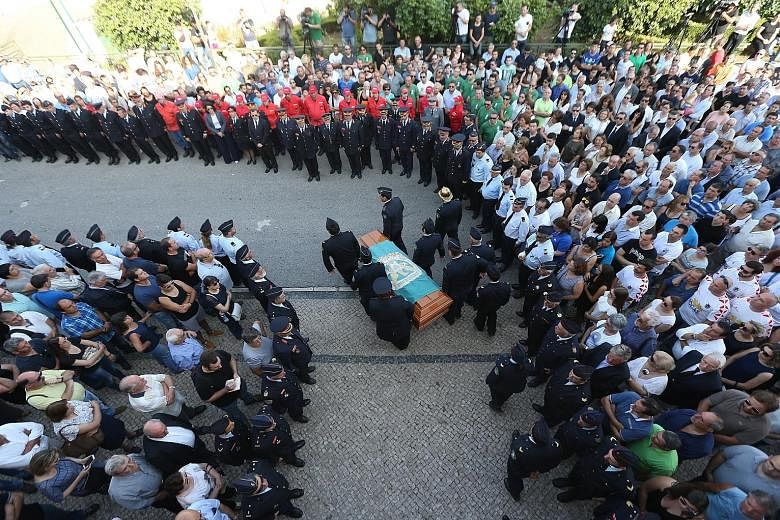 Family members and colleagues attending the funeral ceremony for a fireman in Castanheira de Pera, Portugal, on Wednesday.