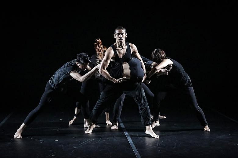 The sparse lighting by designer Adrian Tan enhanced the otherworldly mood and highlighted the sinewy muscles of the dancers in Borderline - By T.H.E Dance Company & Muscle Mouth.