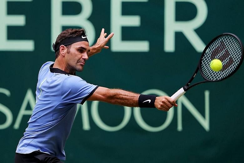 Switzerland's Roger Federer hitting the ball in his second-round match against Mischa Zverev of Germany at the Halle Open on Thursday. The Swiss won 7-6 (7-4), 6-4 to advance to the quarter-finals.