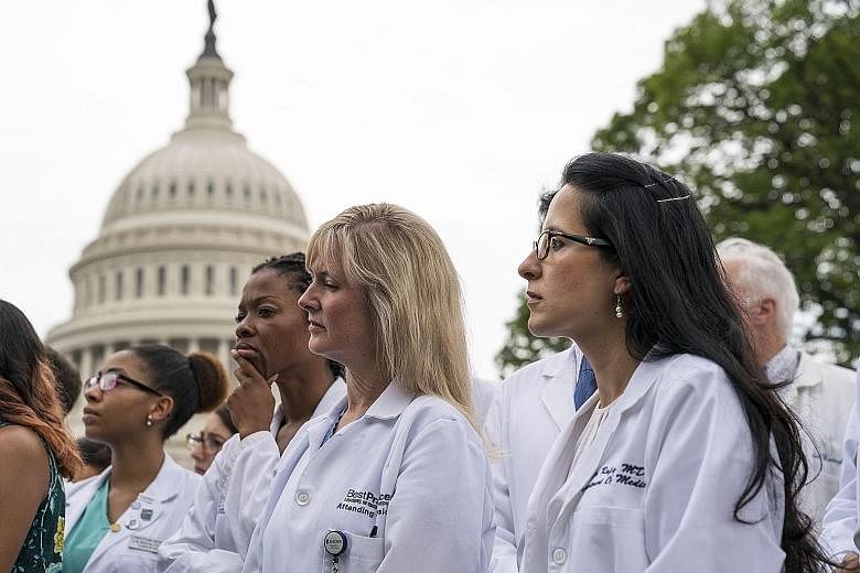 Healthcare workers protesting outside the Capitol on Thursday. Democrats have called the new health plan a "war on Medicaid".