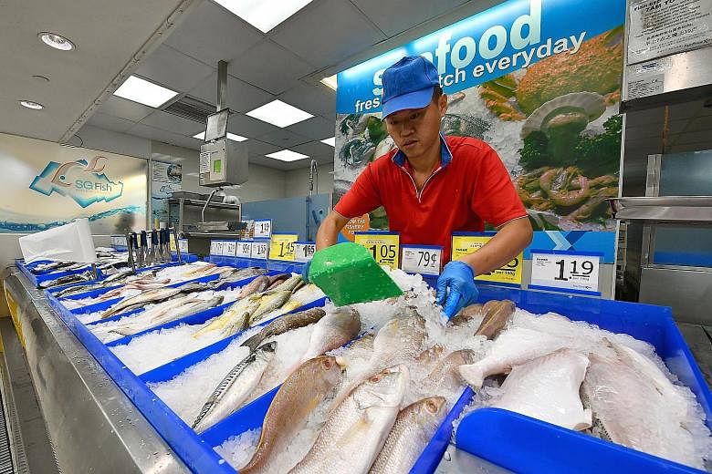 The seafood section at the FairPrice supermarket in Nex mall. Overall food inflation picked up, rising to 1.5 per cent last month from 1.3 per cent in April, driven by a larger increase in the prices of non-cooked food items.