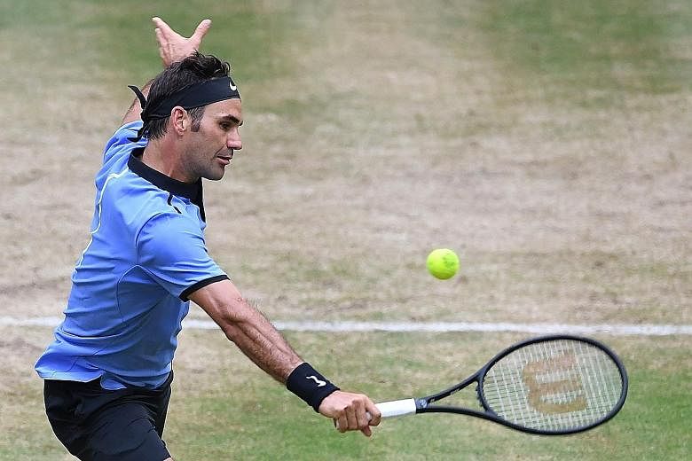 Roger Federer of Switzerland returning the ball to Russia's Karen Khachanov at the Halle Open semi-final yesterday. The Swiss won 6-4, 7-6 (7-5) and will face Alexander Zverev of Germany in today's final.