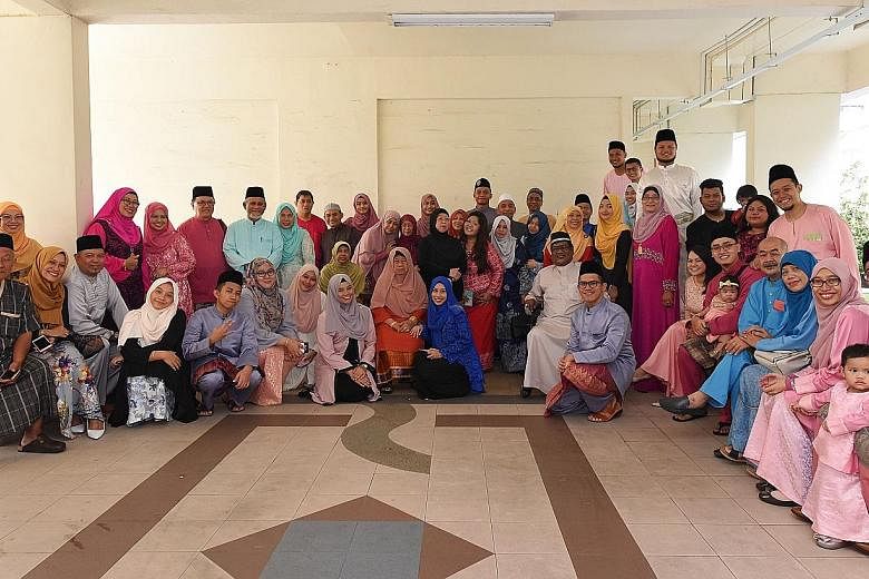 Mr Imis Iskandar (standing, sixth from right, in pink) with his extended family of around 50 members, spanning four generations, as they got together to celebrate Hari Raya Aidilfitri yesterday. He said they are very close and make the effort to get 