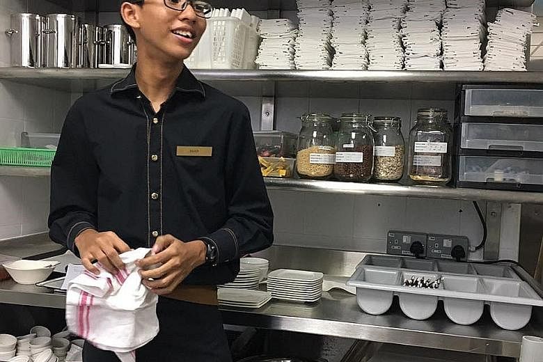 Spectra Secondary student Asad Ali Zainol Abidin during his two-week-long work attachment at the Mandarin Oriental Hotel, where he did room-service functions such as delivering fruit to guests as well as clearing plates and utensils. St Joseph's Inst