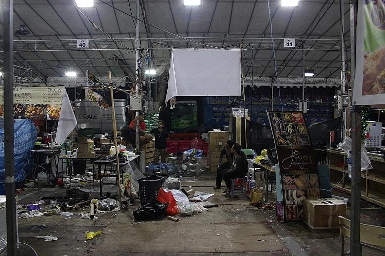 Stalls being dismantled at the Geylang Serai Bazaar just after 5am yesterday as the event drew to an end. Given the high traffic and volume of rubbish usually generated on the bazaar's final night, trash collections are made three times instead of on