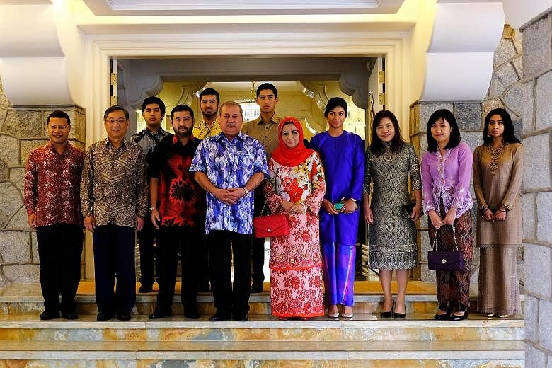 From far left: Ministers Desmond Lee and Gan Kim Yong with Johor Crown Prince Tunku Ismail Sultan Ibrahim, Johor Sultan Ibrahim Sultan Iskandar, Her Royal Highness Raja Zarith Sofiah, other members of the royal family, and Mr Gan and Mr Lee's spouses