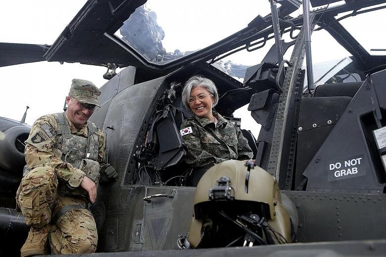 Dr Kang Kyung Wha checking out an AH-64D Apache Longbow helicopter during a visit to Camp Red Cloud at Uijeongbu yesterday. There are hopes that South Korea's new foreign minister, who has successfully balanced work and family, will also break new gr
