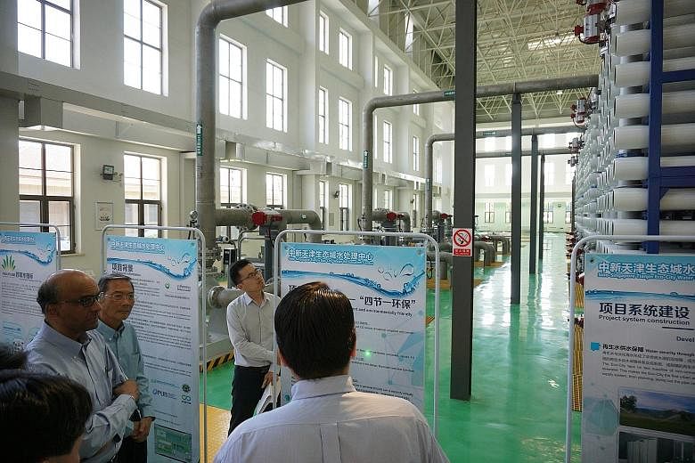 Deputy Prime Minister Tharman Shanmugaratnam and Keppel Corporation chairman Lee Boon Yang at the new water reclamation centre in Tianjin Eco-City yesterday. The new facility, which can treat 100,000 cubic m of wastewater and produce 21,000 cubic m o