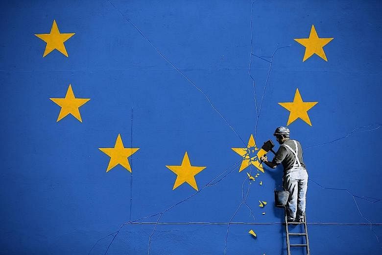 Trip-hop band Massive Attack's Robert Del Naja has been cited as an influence for elusive graffiti activist Banksy, whose work includes a mural (above) depicting a workman chipping away at a star on a European Union flag in England.