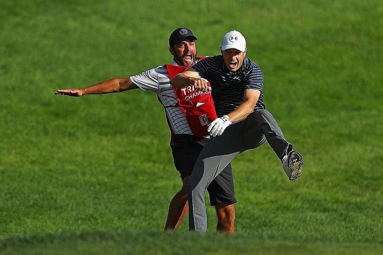 Jordan Spieth enjoying a reverse chest bump with caddie Michael Greller after chipping in for birdie to win the Travelers Championship on the first play-off hole.