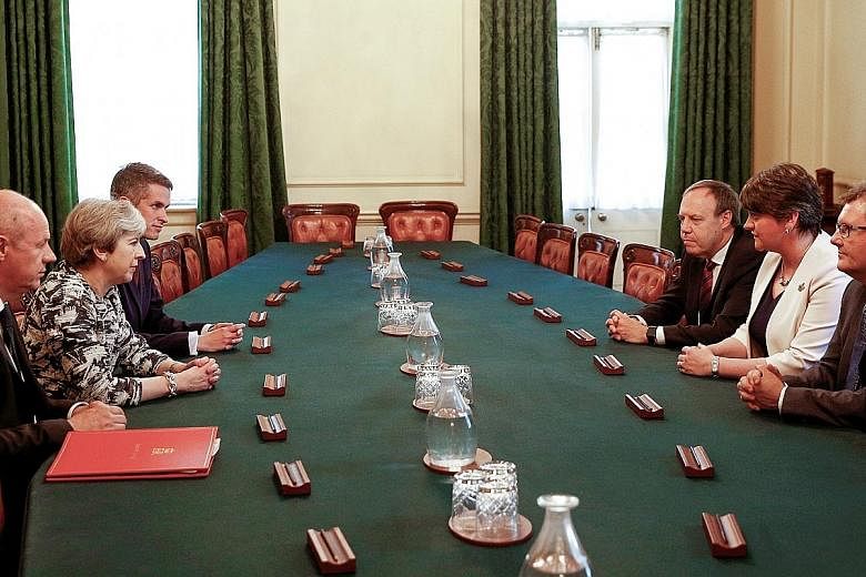 At the meeting yesterday held at 10, Downing Street in London were (clockwise from left) First Secretary of State Damian Green, Prime Minister Theresa May, Conservative Chief Whip Gavin Williamson, and the Democratic Unionist Party's deputy leader Ni