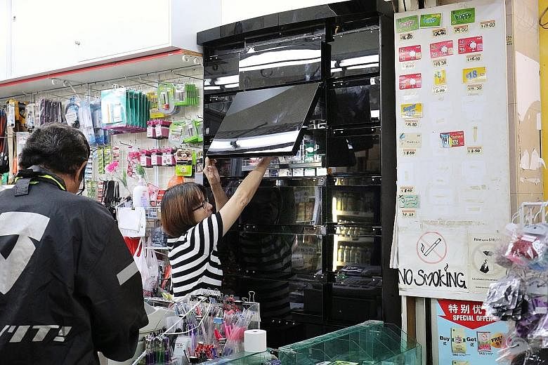 Good Price Centre, a convenience store in Ang Mo Kio Avenue 1, has been using black opaque glass cabinets for its cigarettes since last week. The point-of-sale display ban for tobacco products begins in August.