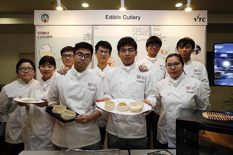 Nine graduates from Hong Kong's International Culinary Institute, led by Mr Raymond To (holding white plate), exhibiting their Edible Cutlery project at ITE College West yesterday.