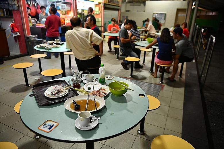 Used plates and cutlery left behind by customers at a hawker centre at Block 210, Toa Payoh Lorong 8, yesterday. Findings from the Graciousness Survey released yesterday showed that people rated Singapore 5.52 for "cleaning up after meals in public s