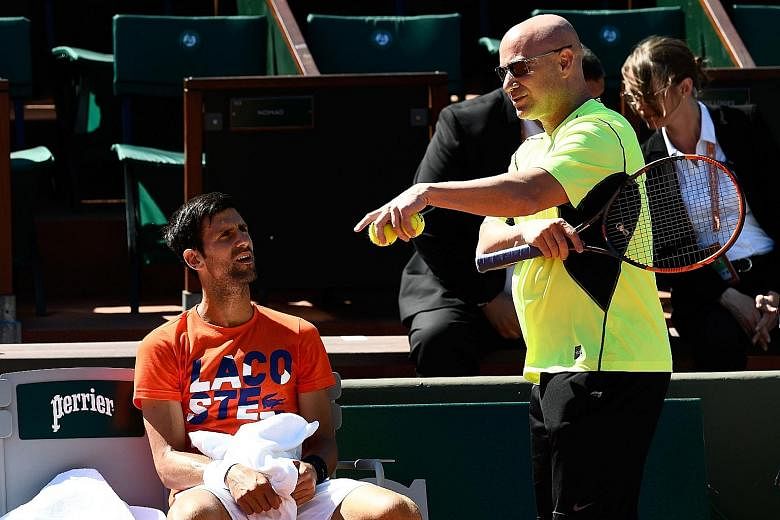 Andre Agassi (right) giving Novak Djokovic feedback at a training session during his short-lived French Open campaign this month. The American will be back to assist the Serb in his attempt to clinch a fourth Wimbledon singles title.