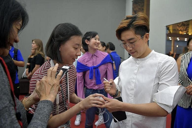 Feng Tianwei signing autographs for fans in Johor Bahru yesterday. The only Singaporean participant said the time-based format will test players' mettle.
