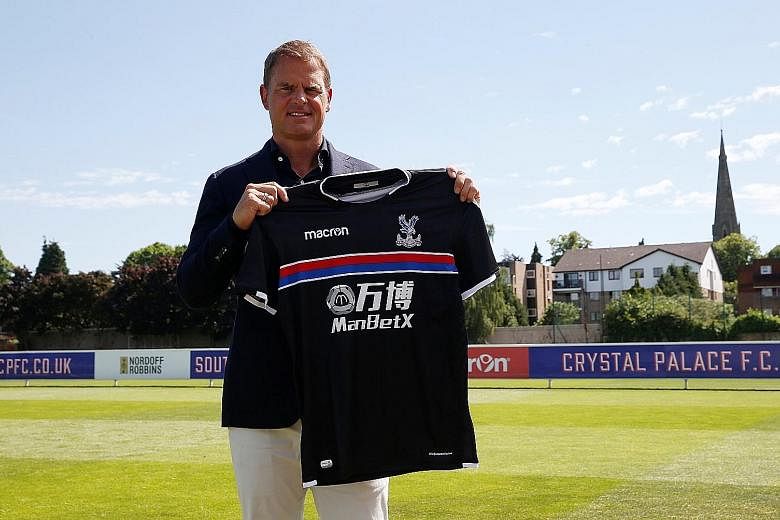 Newly-appointed Crystal Palace manager Frank de Boer posing with the club jersey. The Dutchman will seek to retain the defensive solidity that Sam Allardyce drilled into the squad while transitioning towards a more possession- based playing style.