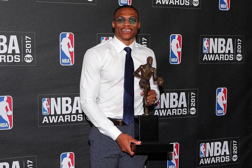 Oklahoma City Thunder guard Russell Westbrook posing with the NBA MVP trophy at the inaugural NBA Awards show. He had a standout season with a league-high of 31.6 points, 10.7 rebounds and 10.4 assists a game.