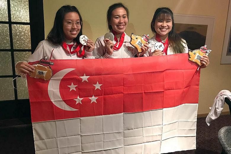 Singapore shooters (from left) Adele Tan, Ho Xiu Yi and Martina Lindsay Veloso celebrating their silver.