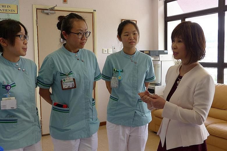 Senior Minister of State for Health, Dr Amy Khor, talking to nursing students at Shatin Hospital's Palliative Day Care Centre.