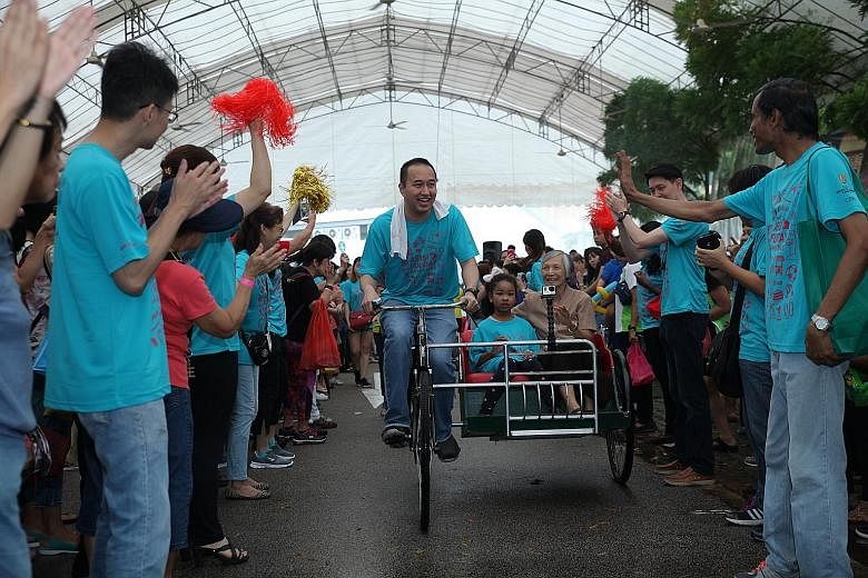Mr Sherman Kwek, deputy CEO of City Developments, riding a trishaw carrying Sister Florence Wong and Gracelyn Ng during the fund-raiser. The June 18 event raised more than $76,000 for Assisi Hospice.