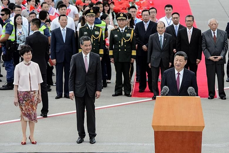 Chinese President Xi Jinping giving a speech at the Hong Kong International Airport yesterday, with Hong Kong's outgoing Chief Executive Leung Chun Ying and incoming leader Carrie Lam beside him. "Hong Kong has always had a place in my heart," said M