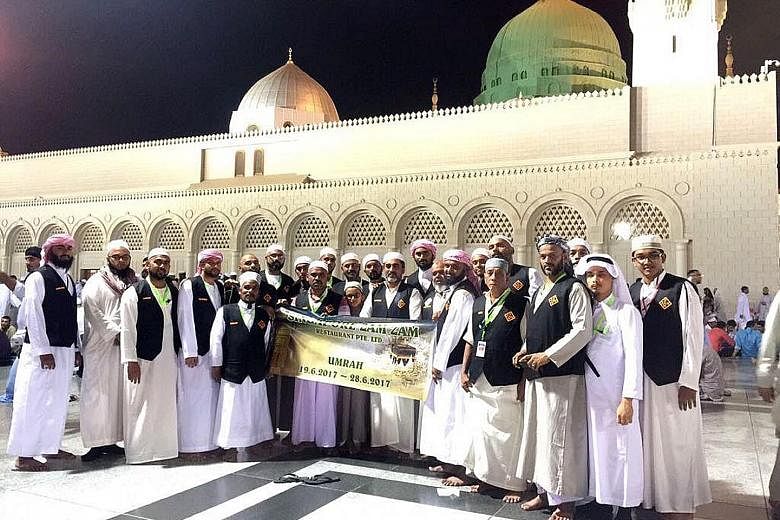 Some of the Zam Zam staff during their sponsored umrah, or minor pilgrimage, to Mecca. They wore Zam Zam vests for easy identification and took along a banner which they posed with for photos.