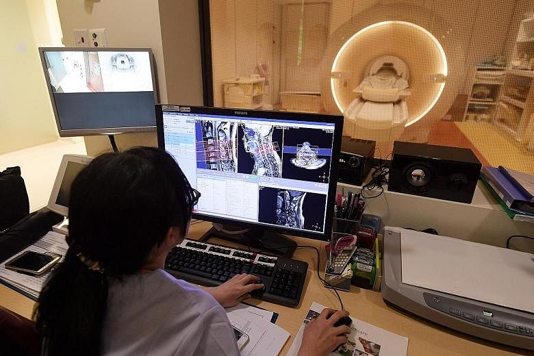 A radiographer at work in the MRI room of Singapore General Hospital. Doctors say MRI technology continues to improve, and the experience is also more comfortable for the patient.