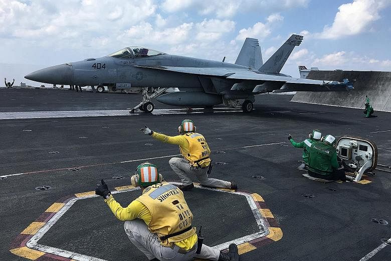 Fighter planes being launched from the nuclear-powered aircraft carrier USS Ronald Reagan in the South China Sea earlier this month. According to the writer, what purports to be current US policy towards the South China Sea is a continuance of the Ob