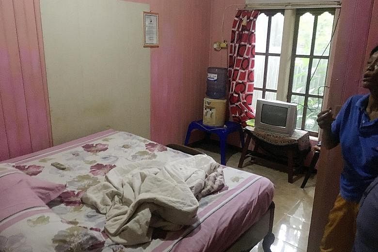 Khasanah (above) was detained on Tuesday in the town of Tungkal Ilir in West Tanjung Jabung regency in Indonesia's Jambi province, after local police raided her room (left) at Hotel Nanber following a tip-off from residents. The maid was seen browsin