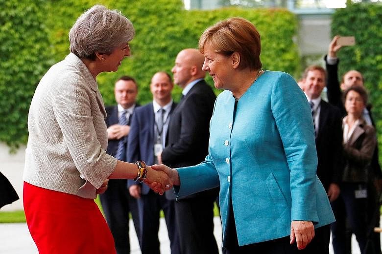 It was a busy day yesterday for British Prime Minister Theresa May, seen here being welcomed by German Chancellor Angela Merkel, in Berlin. She jetted into Germany for a meeting with other world leaders ahead of the Group of 20 (G-20) summit, then he