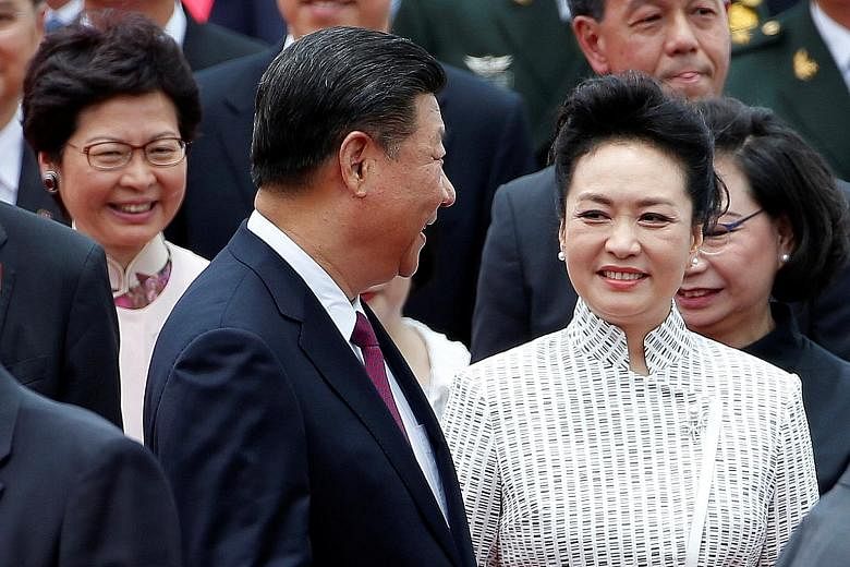 Mr Xi Jinping and his wife, Ms Peng Liyuan, being met by Chief Executive-elect Carrie Lam (behind left) in Hong Kong yesterday.