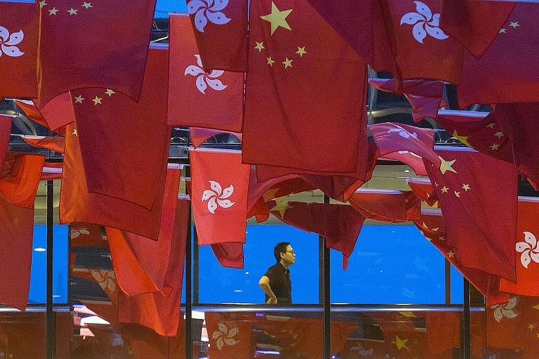 A bridge in Hong Kong decorated with China's and Hong Kong's flags ahead of the special administrative region's handover anniversary. Hong Kong is marking the 20th anniversary of the former British colony's return to Chinese rule tomorrow. It is the 