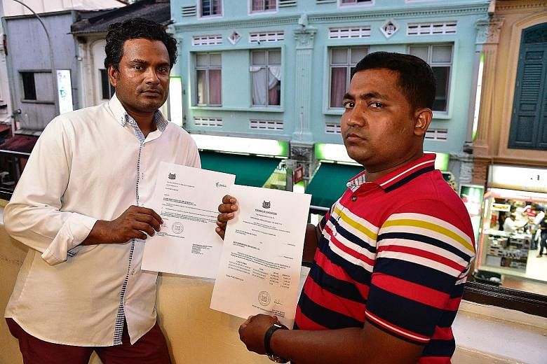 Mr Alam Ataur Rahman (left) and Mr Islam Mohd Rubayet with their respective Labour Court awards. Pro-bono lawyers arranged by non-governmental organisation Transient Workers Count Too are trying to recover the debts for the two men. Their former empl