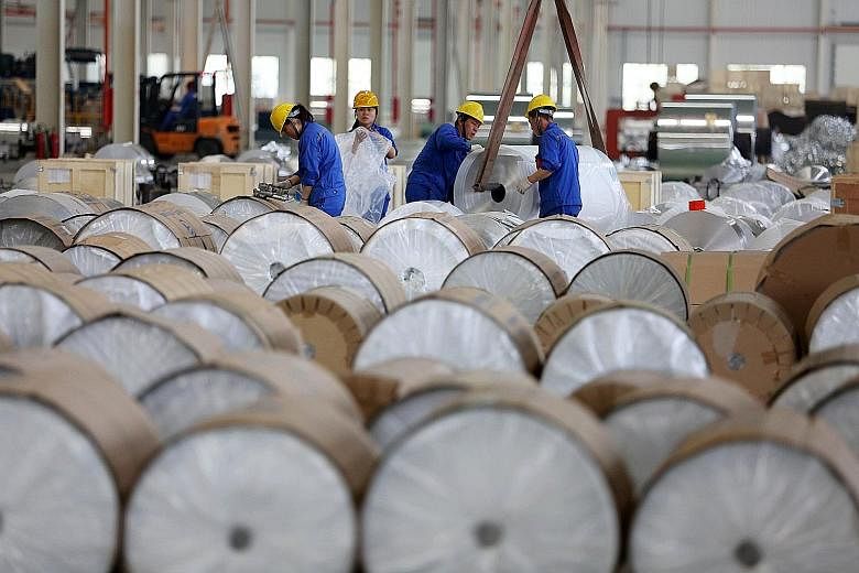 Workers packaging aluminium tapes in China's Anhui province. The manufacturing PMI was at 51.7 last month.