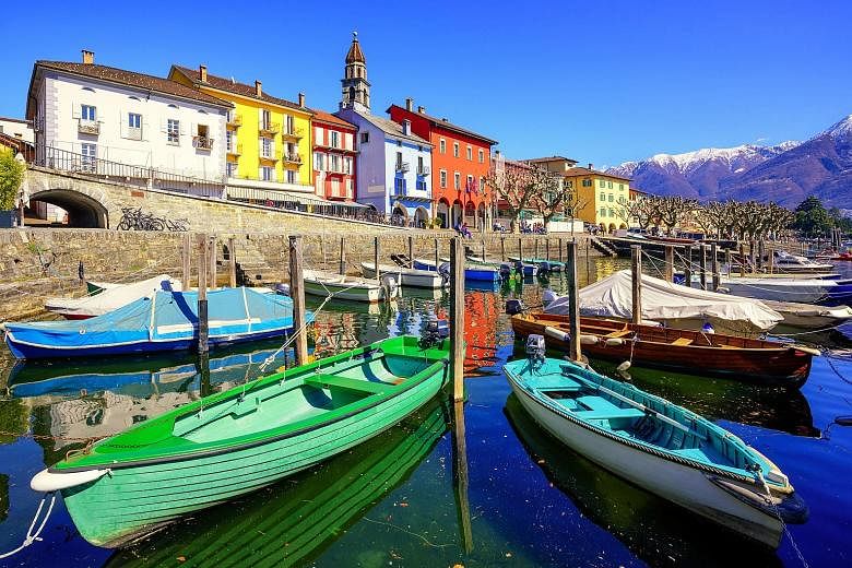 Vibrant-coloured boats stand out in the old town of Ascona.